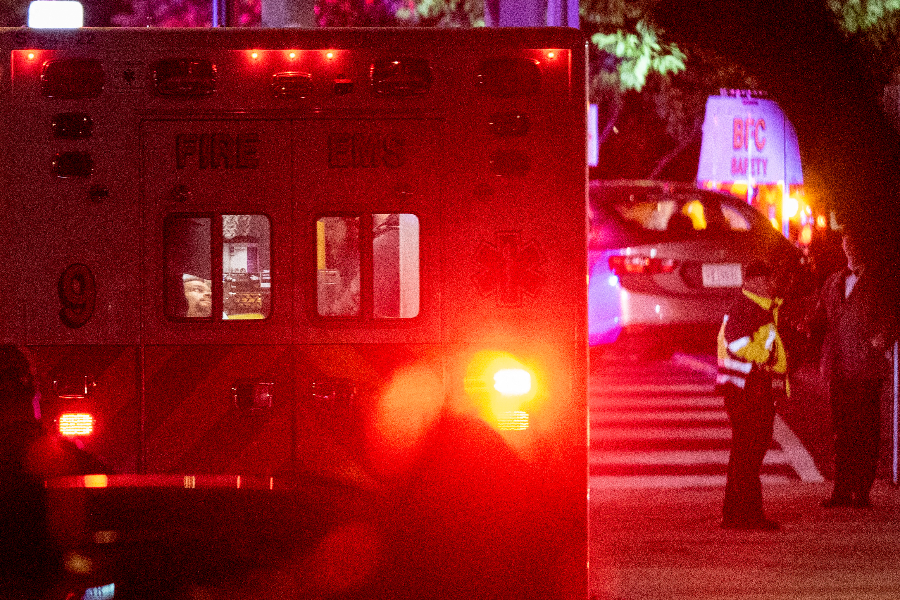 A man on a gurney being taken away in an ambulance outside the Washington Hilton hotel
