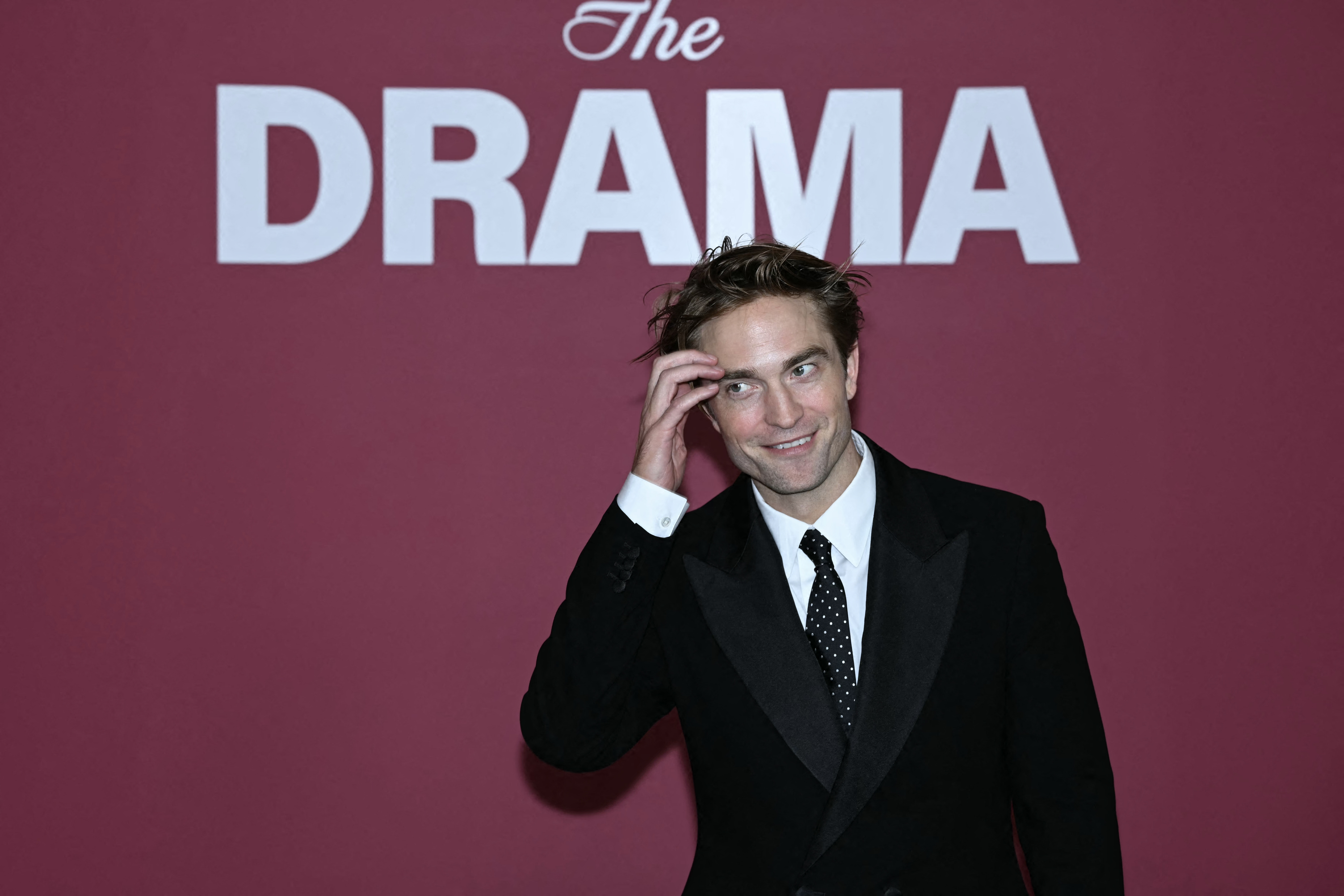 Robert Pattinson posing at a photocall for the film Drama in Paris
