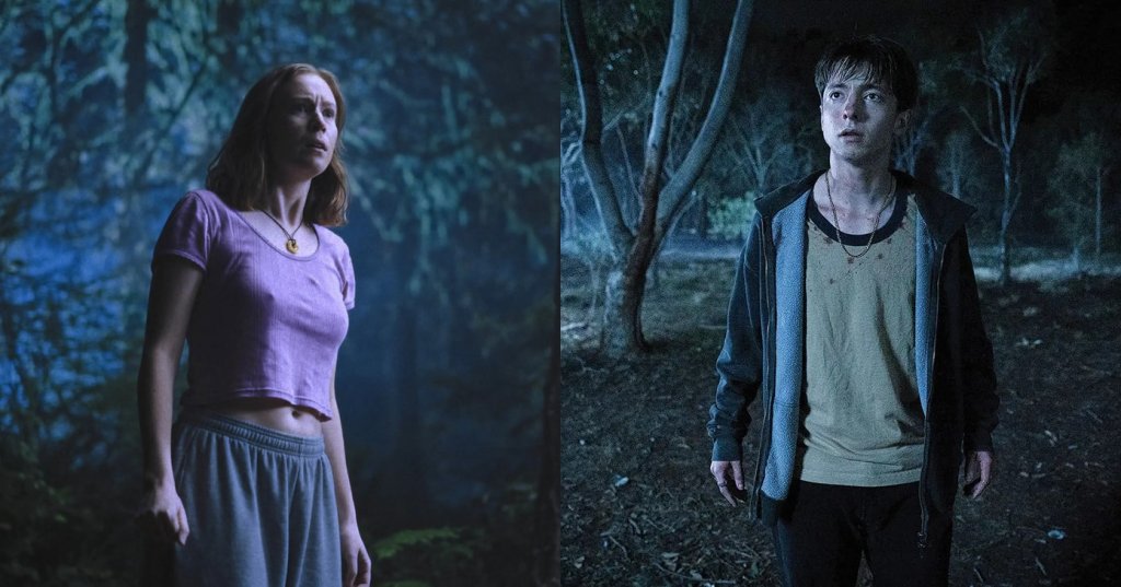 A red-haired woman in a pink crop top and gray skirt stands alone in a dark forest, gazing upward with a frightened expression.