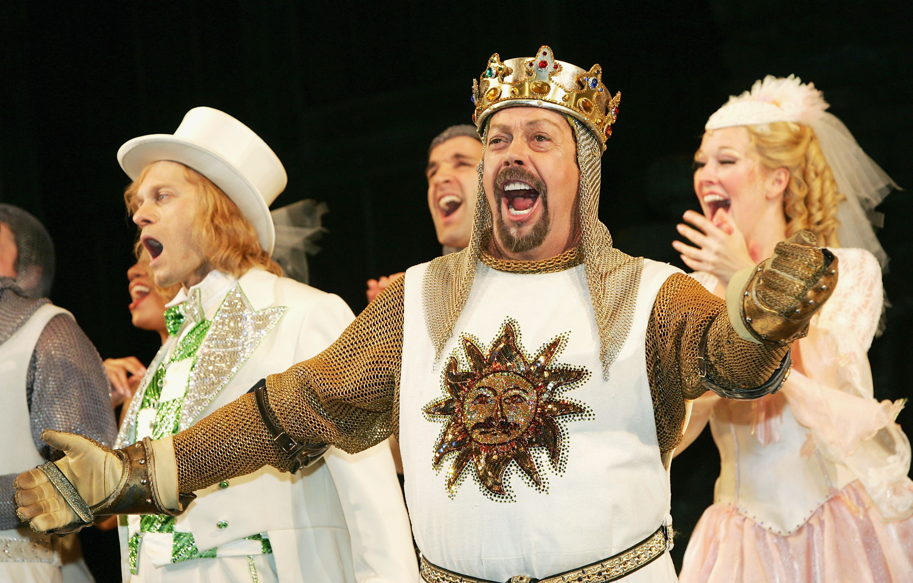 Tim Curry singing on stage during the curtain call for Monty Python's Spamalot at the Shubert Theatre in New York
