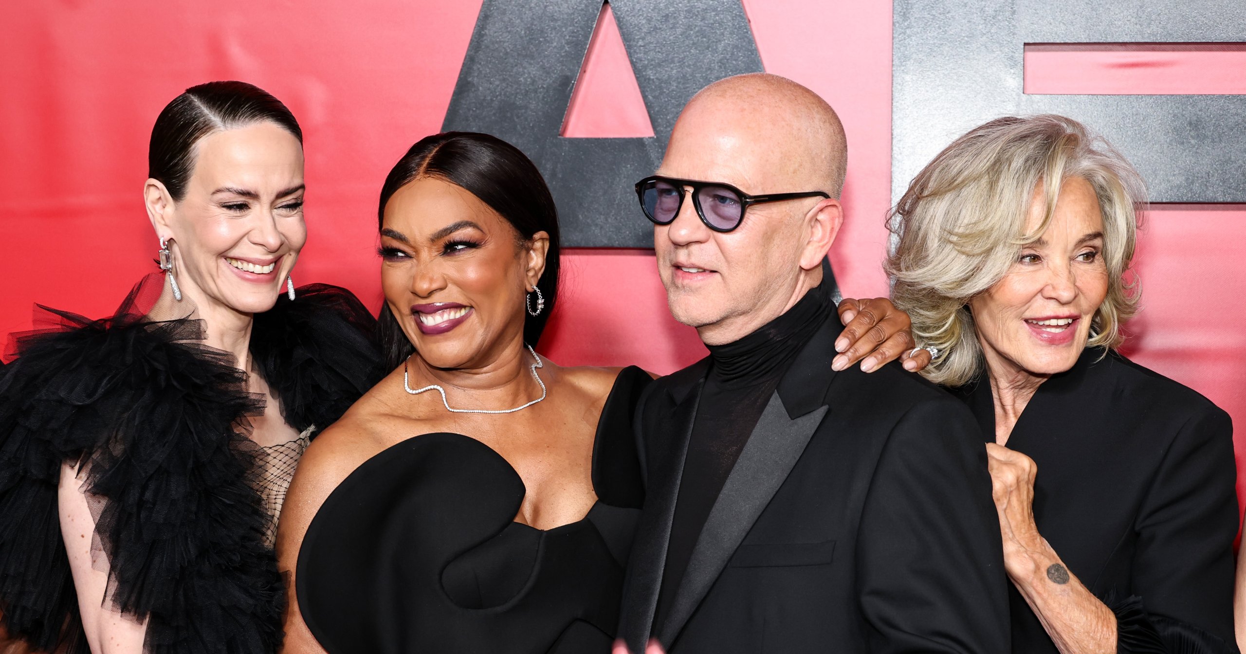 Sarah Paulson, Angela Bassett, Ryan Murphy, and Jessica Lange posing together in black outfits at the American Horror Story: 13 celebration event.