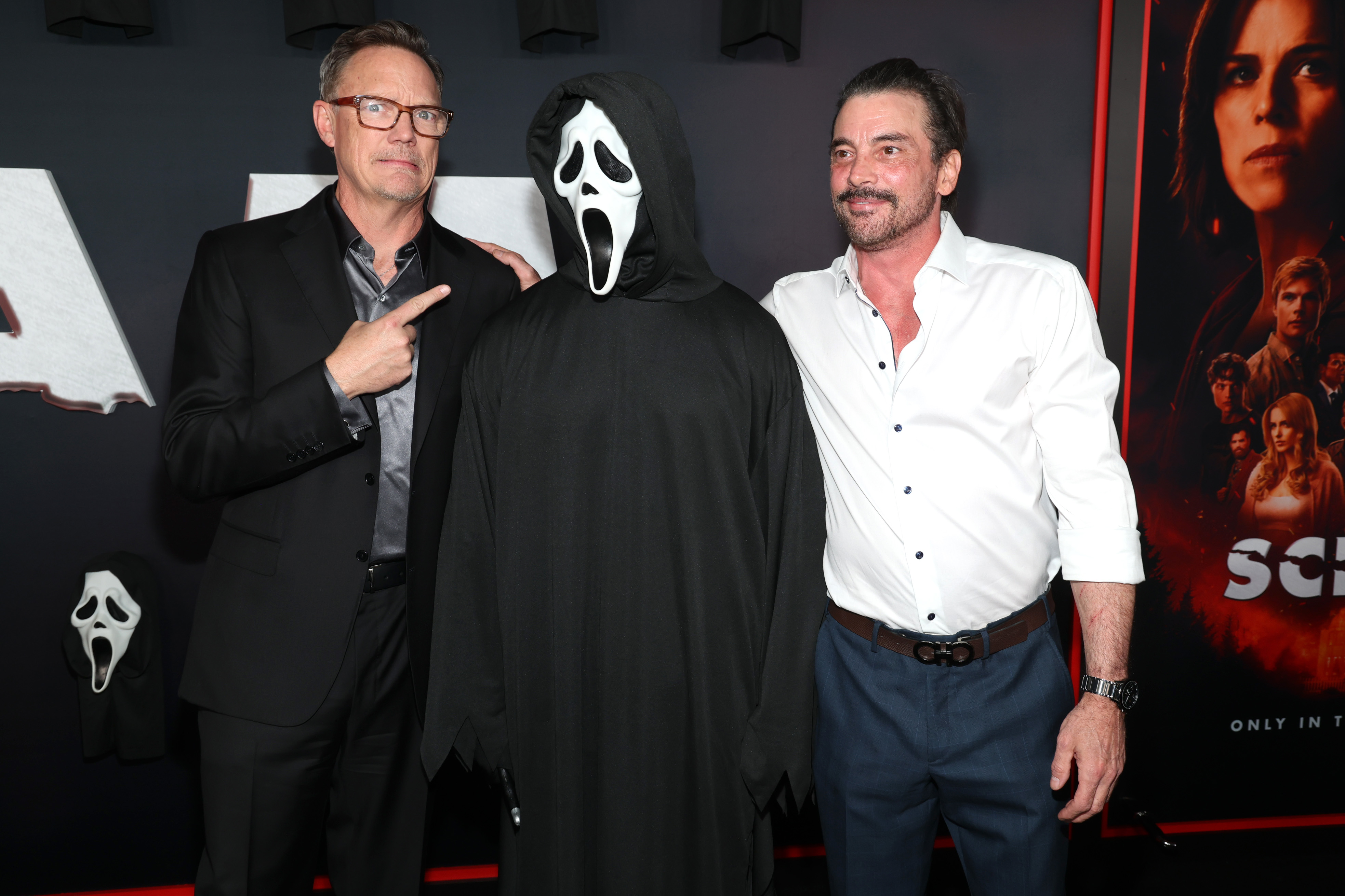 Matthew Lillard and Skeet Ulrich posing with Ghostface at the Scream 7 global premiere at Paramount Pictures Studios
