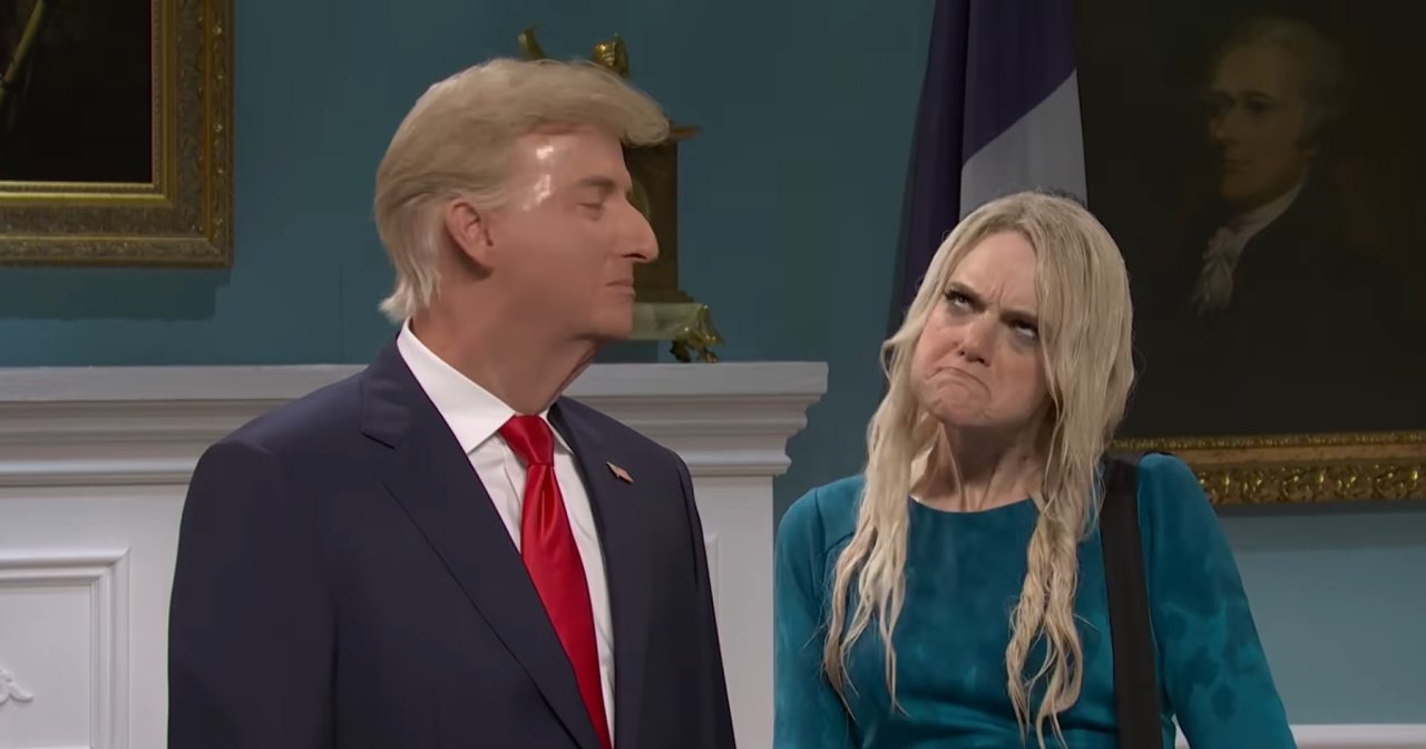 Two SNL performers in costume — one dressed as Trump in a suit and red tie, the other as a blonde woman in a teal dress making an exaggerated grimace.