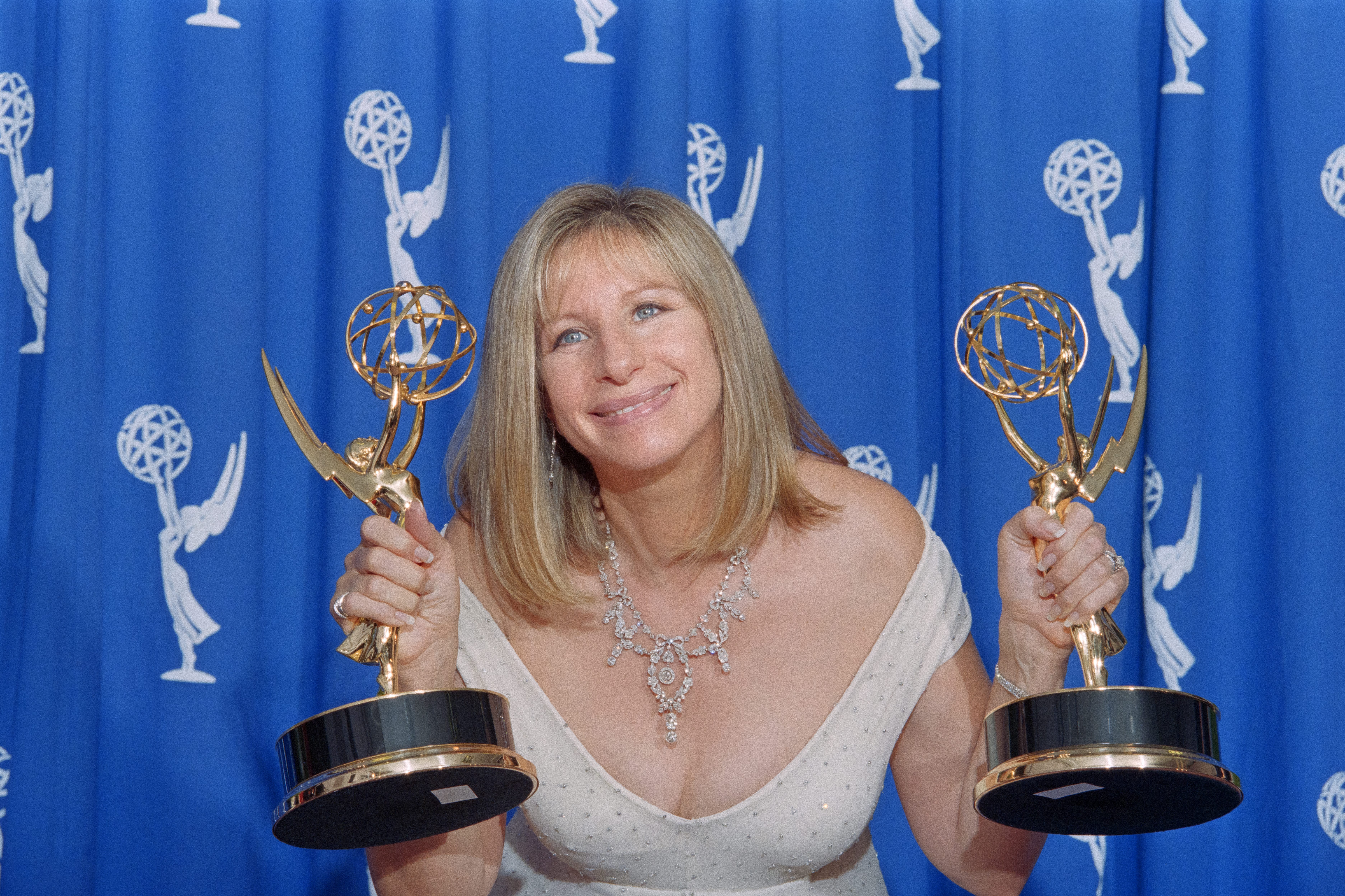 Barbra Streisand holding up two Emmy awards at the 47th Primetime Emmy Awards in Pasadena, California