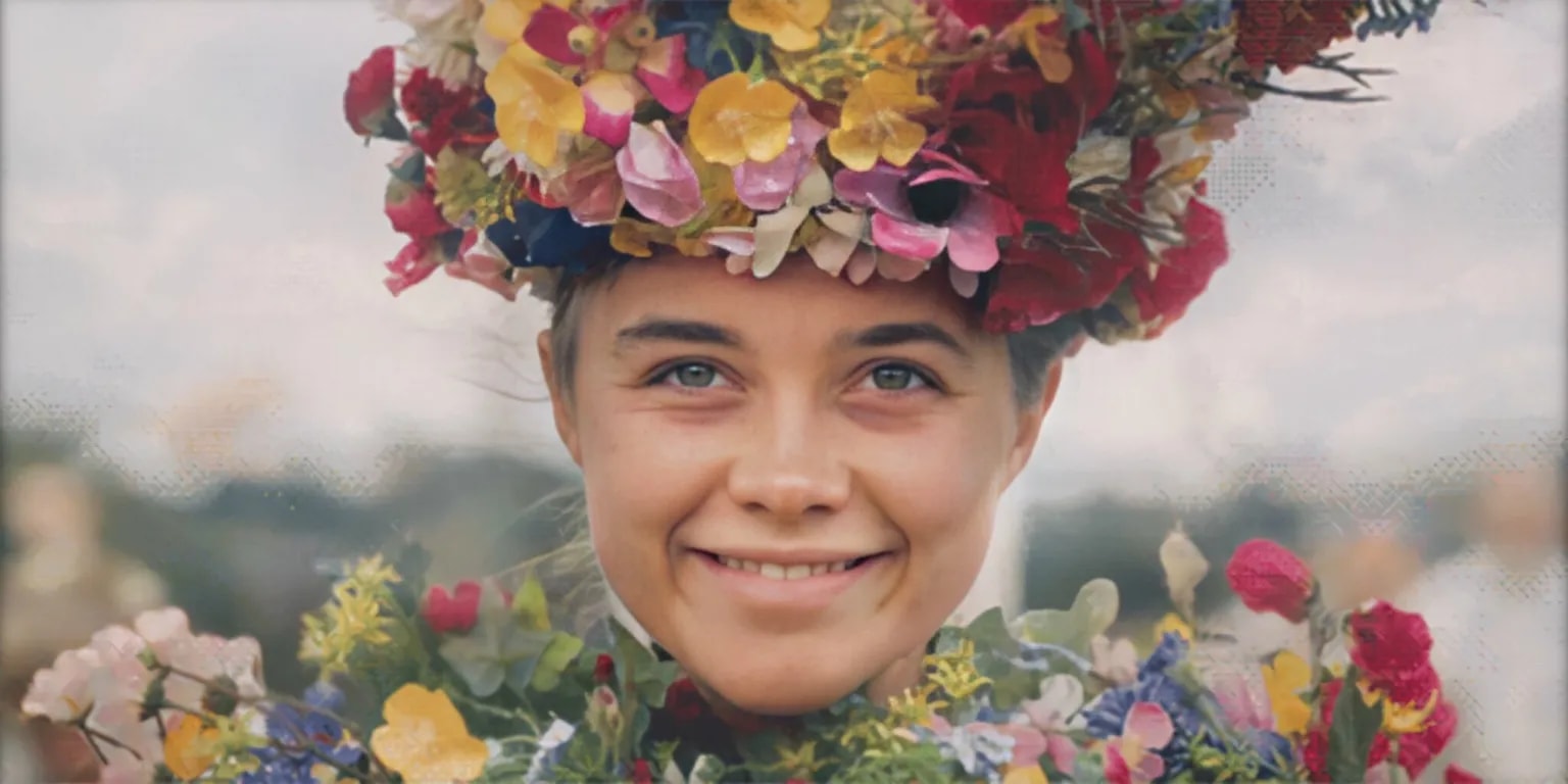 Smiling young woman wearing a large floral crown and surrounded by colorful flowers against an overcast sky.