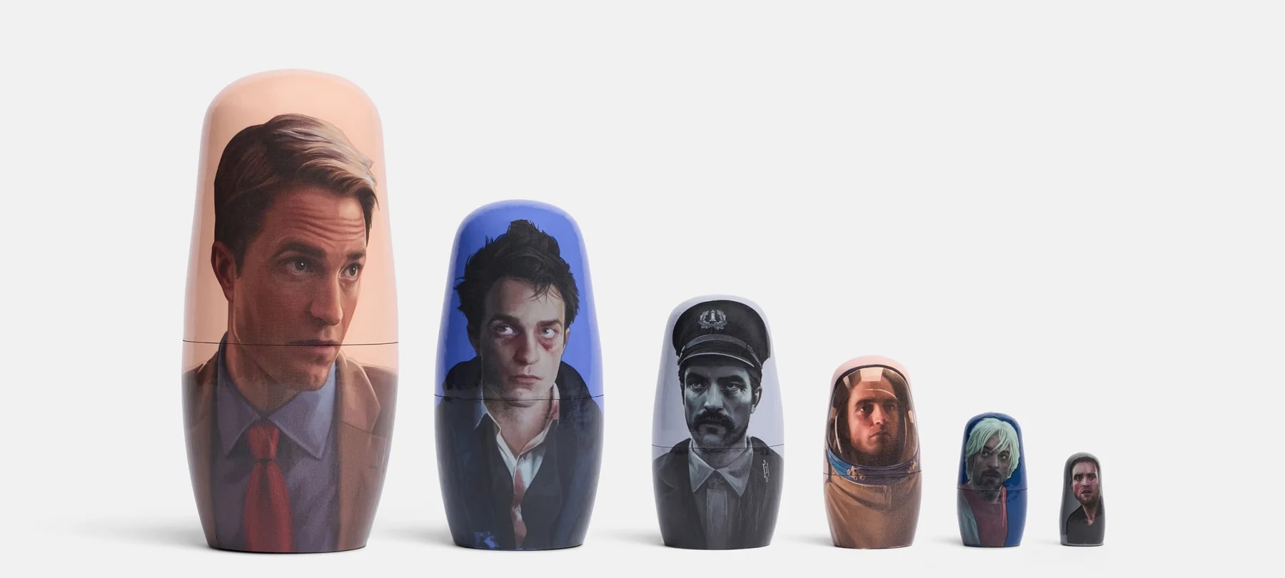 A24 wooden nesting dolls featuring six Robert Pattinson film characters, stacked by size