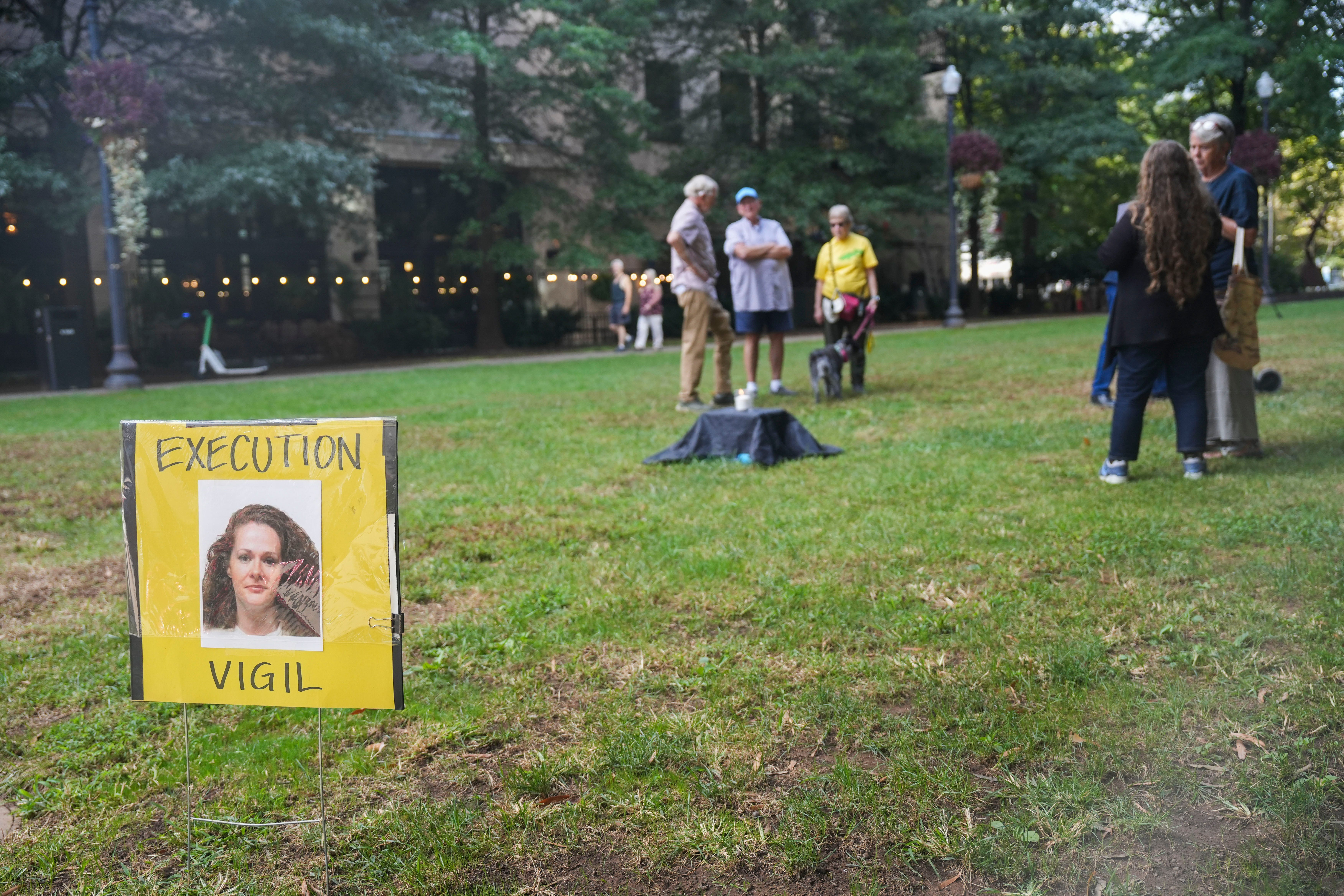 Demonstrators hold a vigil for Christa Pike, who is on death row for killing 19-year-old Colleen Slemmer in 1995, in Krutch Park in Knoxville, Tenn., on Sept. 30, 2026. (+2 more)