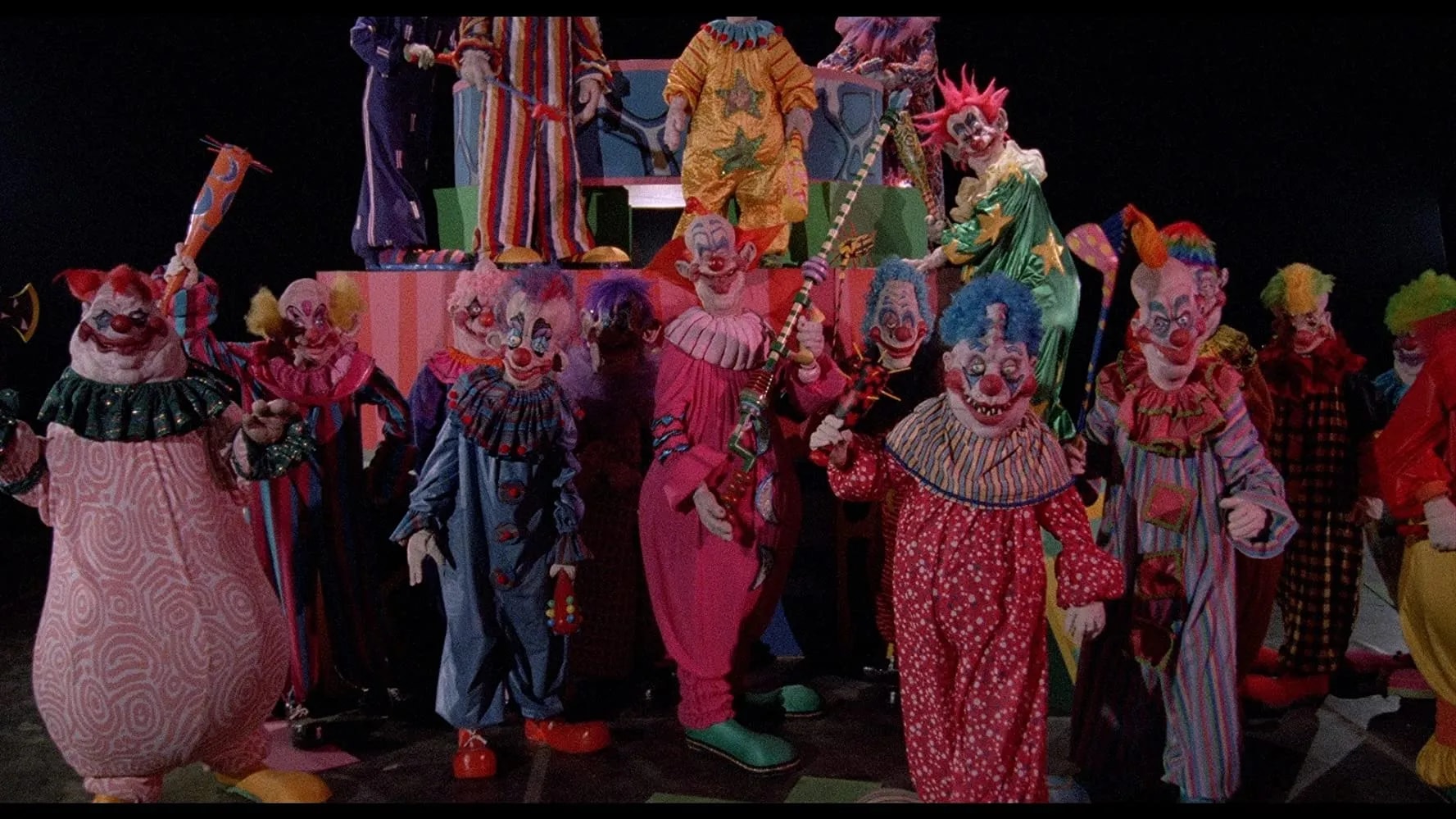 A still from Killer Klowns from Outer Space featuring the film's iconic alien clown characters