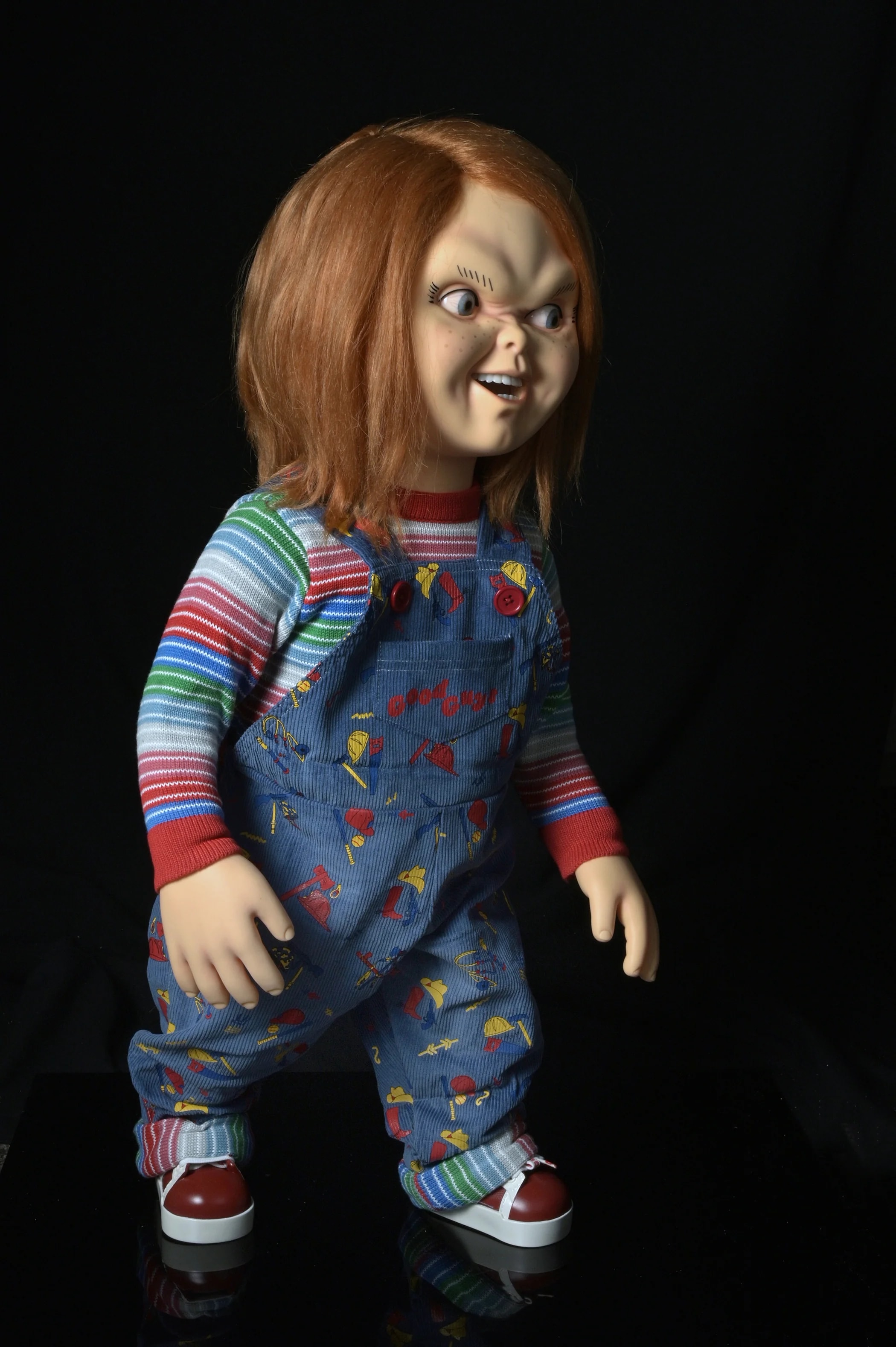 Life-size NECA Chucky and Tiffany replica dolls standing side by side in their collector packaging
