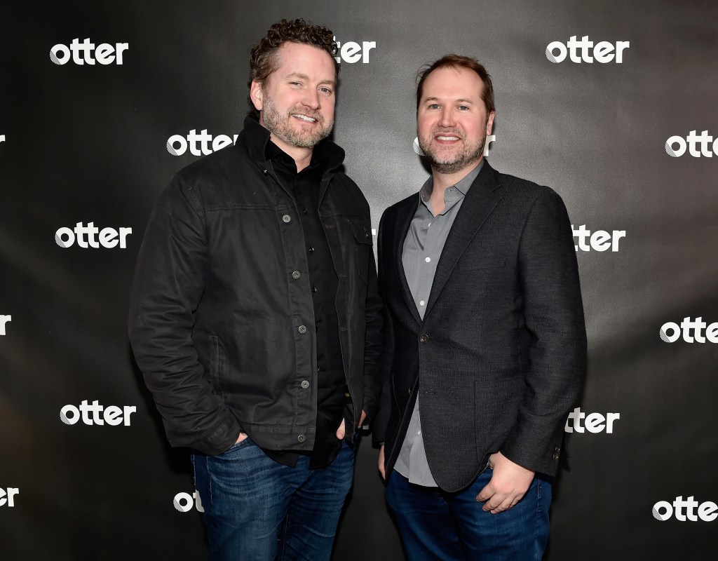 Burnie Burns and Matt Hullum standing together at a Rooster Teeth event at Sundance 2019 in Park City, Utah