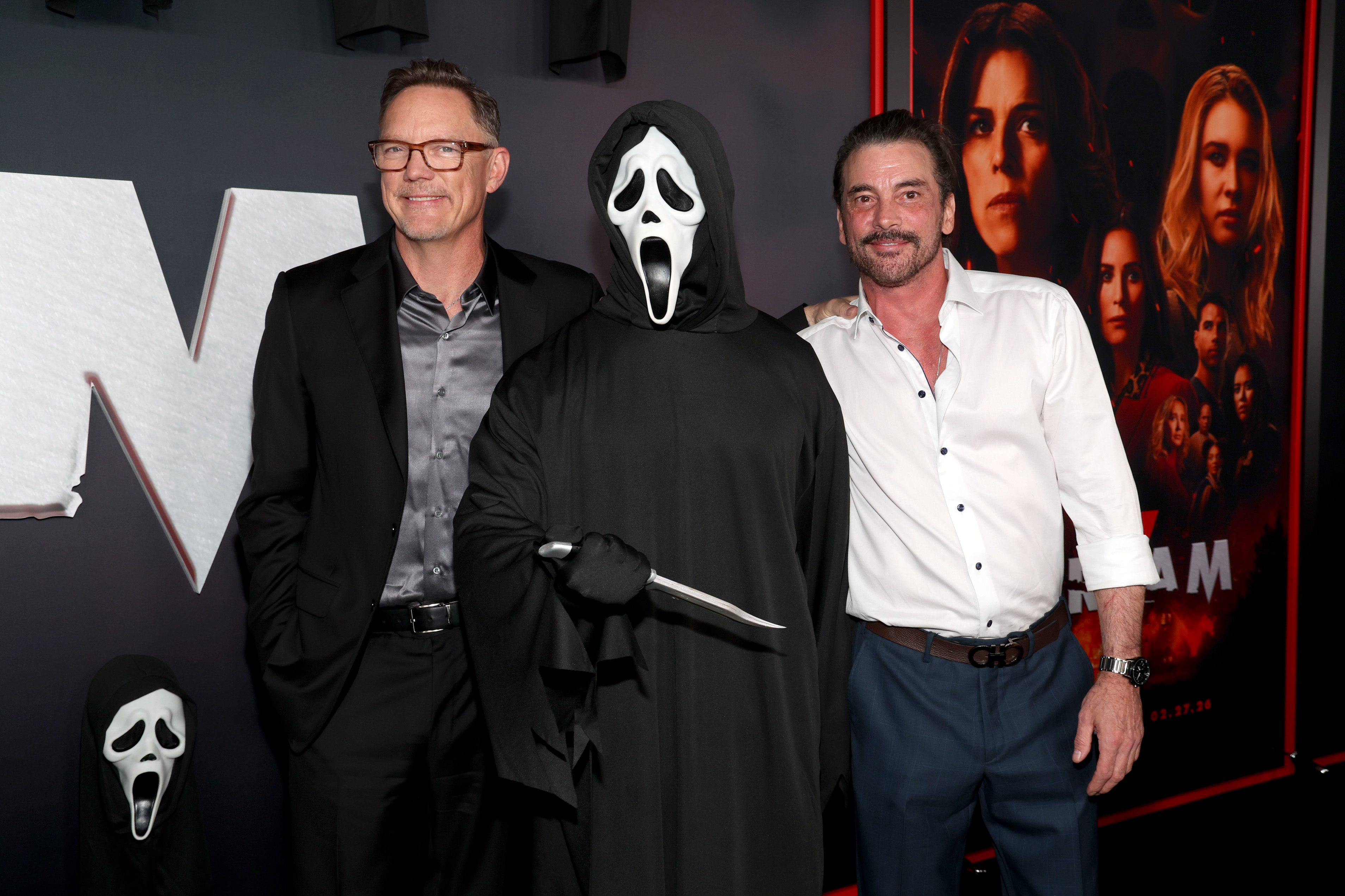 Matthew Lillard and Skeet Ulrich pose on either side of a person in a Ghostface costume at the Scream 7 premiere in Los Angeles.