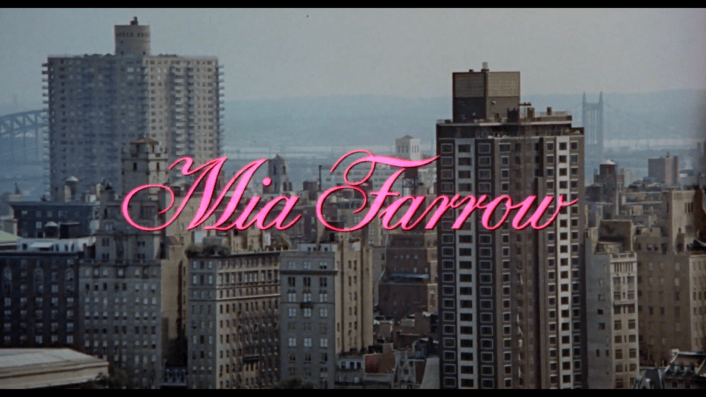 Pink cursive title card reading "Rosemary's Baby" over the New York City skyline in the 1968 film's opening credits.