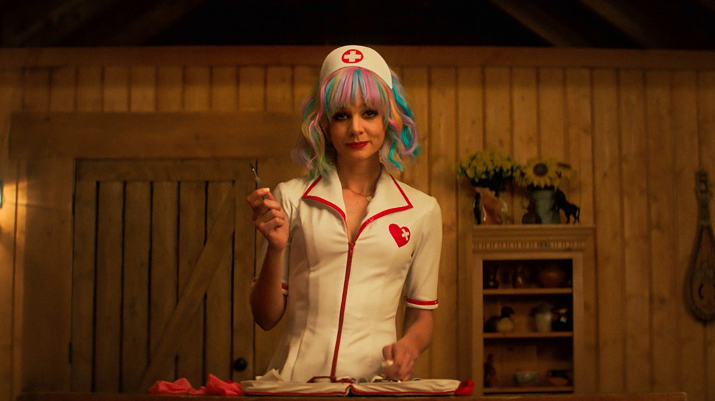Carey Mulligan as Cassie wearing a white nurse costume and colorful rainbow wig in Promising Young Woman